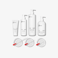 The Complete Skin Savior Set by Basic Maintenance features five white containers—tubes and pump bottles—and three small clear dishes with red-handled droppers, all arranged on a plain white background.