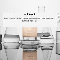 A five-star testimonial overlays lab glassware and a candle, praising The Calm’s scent and clean burn, signed by D.F., from Basic Maintenance.