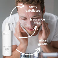 A man gently cleanses his face with The Face Wash by Basic Maintenance. Text with arrows points out that its ultra gentle, softly exfoliates, and is fragrance-free. A white bottle labeled The Face Wash appears in the foreground.